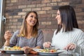 Two girlfriends having lunch together at a restaurant Royalty Free Stock Photo