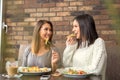 Two girlfriends having lunch together at a restaurant Royalty Free Stock Photo
