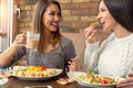 Two girlfriends having lunch together at a restaurant Royalty Free Stock Photo