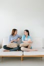 Two girlfriends having a talk on the couch at home Royalty Free Stock Photo