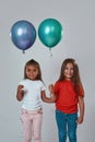 Two girlfriends hold balloons and look at camera Royalty Free Stock Photo