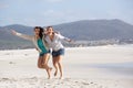 Two girlfriends laughing at the beach Royalty Free Stock Photo