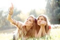 Two girlfriends outdoor looking upwards Royalty Free Stock Photo