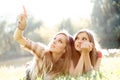 Two girlfriends outdoor looking upwards