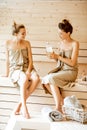 Two girlfriends relaxing in the sauna