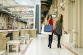 Two girlfriends on shopping walk on shopping mall with bags Royalty Free Stock Photo