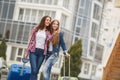 Two girlfriends with suitcases awaiting departure at the airport Royalty Free Stock Photo