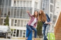 Two girlfriends with suitcases awaiting departure at the airport Royalty Free Stock Photo