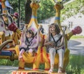 Two girls with admiration go for a drive on the carousel Royalty Free Stock Photo