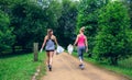 Two girls on back doing plogging Royalty Free Stock Photo