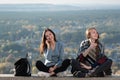 Two girls on the background of nature laugh. Travel with a friend. Front view