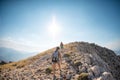 two girls with backpacks walk along a mountain path Royalty Free Stock Photo