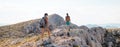 two girls with backpacks walk along a mountain path Royalty Free Stock Photo