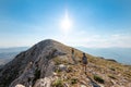 two girls with backpacks walk along a mountain path Royalty Free Stock Photo