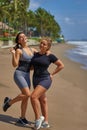 Two girls on the beach in sweat belt