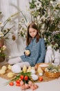 Two girls in a beautiful Easter photo zone with flowers, eggs, chickens and Easter bunnies. Happy Easter holiday. Royalty Free Stock Photo