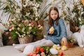 Two girls in a beautiful Easter photo zone with flowers, eggs, chickens and Easter bunnies. Happy Easter holiday. Royalty Free Stock Photo