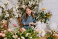 Two girls in a beautiful Easter photo zone with flowers, eggs, chickens and Easter bunnies. Happy Easter holiday. Royalty Free Stock Photo