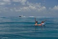 Two girls in bikinis on floating device at open waters Royalty Free Stock Photo