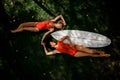 Two girls lying on the two sides of the wakeboard Royalty Free Stock Photo