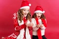 Two girls are blowing fake snow Royalty Free Stock Photo