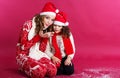 Two girls are blowing fake snow in studio Royalty Free Stock Photo