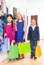 Two girls and boy with colorful shopping bags Royalty Free Stock Photo