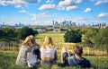 Two girls and a boy look at London`s skyline from Greenwich Park Royalty Free Stock Photo