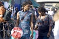 Two girls with braids in beautiful dresses, go on a sunny day at Brick lane