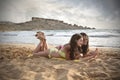 Two girls chatting at the beach Royalty Free Stock Photo