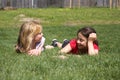 Two girls chatting in grass Royalty Free Stock Photo