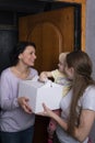 Two girls and child with cake in box. Mom came to visit her daughter