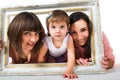 Two girls and child holding wooden white frame Royalty Free Stock Photo