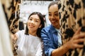 Two girls choosing dresses in clothing store Royalty Free Stock Photo