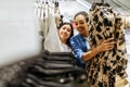 Two girls choosing dresses in clothing store Royalty Free Stock Photo