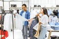 Two girls choosing trousers in clothing store Royalty Free Stock Photo