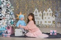 Two girls in a Christmas decorated studio in pastel colors