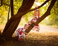 Two girls climbing a tree in the park. Copy space