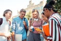 Two girls comparing their timetables in front of groupmates. Royalty Free Stock Photo