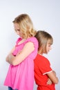 Two girls in conflict standing back to back Royalty Free Stock Photo