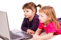 Two girls at the copmuter playing Royalty Free Stock Photo