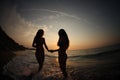 Girls DANCING IN SUNSET ON SEA Royalty Free Stock Photo