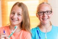 Two girls with dental retainers brushing teeth Royalty Free Stock Photo