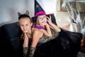 Two girls disguised as a tiger and as a witch are waiting for some candies in All Saints' Day. Royalty Free Stock Photo