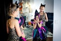 Two girls disguised as a tiger and as a witch are wriggling in front of the mirror in All Saints' Day Royalty Free Stock Photo