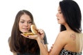 Two girls divide one sandwich