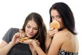 Two girls divide one sandwich