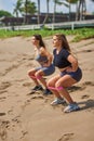 Two girls do fitness on the beach