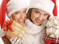 Two Girls Dressed as Santa Claus Happily Hold Boxes With Gifts