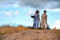 Two girls in dresses in autumn field Royalty Free Stock Photo